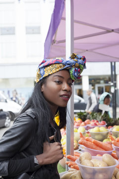 Woman wearing a headscarf at a fruit market