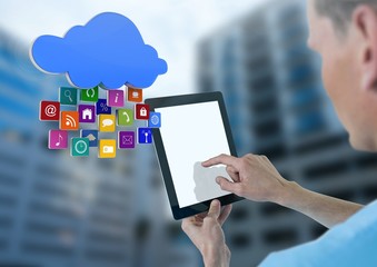 Doctor holding tablet with apps with tall buildings