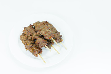 Grilled pork with bamboo stick in white dish on white background,Thai styled grill pork barbeque