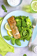 Grilled salmon garnished with green vegetables.Top view.