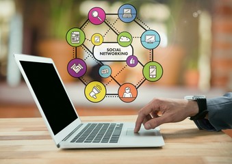 Businessman on laptop in cozy warm room with apps