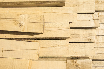 Piled lumber near a lumber mill, waiting for shipping. Wood Mill. Lumber and wood slice.