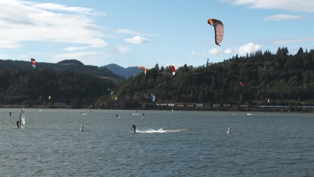 A busy day on the Columbia River in Hood River, Oregon as kite surfers  and wind boarders take advantage of a warm and windy day.