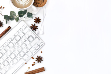Flat lay, top view office table desk. Workspace with laptop, coffee cup, scissors and clips on white background.
