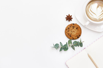 Workspace with cup of coffee, cookies and leaf. Flat lay composition for bloggers, magazines, social media and artists. Top view.