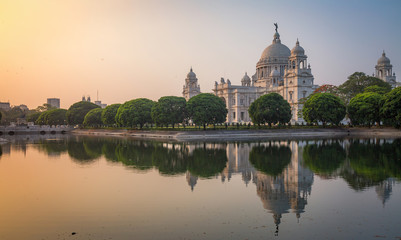 Victoria Memorial - A white marble historic monument and museum at sunrise with moody sky. 