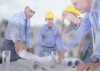 Architect with blueprints on building site