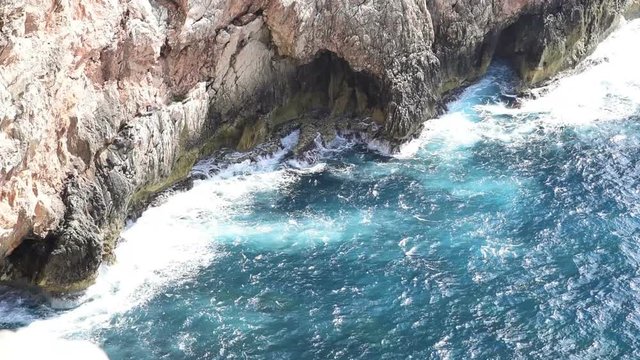 Rocks and blue water in Capo Caccia shore