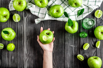 summer food with green apples on dark background top view