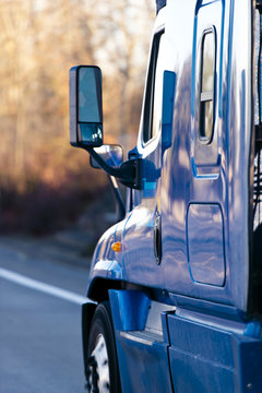 Blue modern semi truck with lot of reflaction