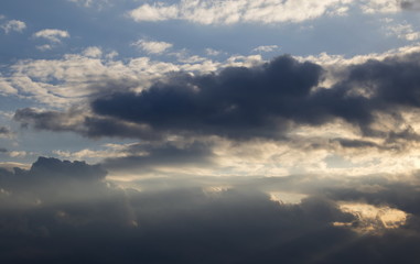 Cumulus clouds with sun rays, dramatic sky