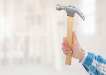 Hand with hammer on building site