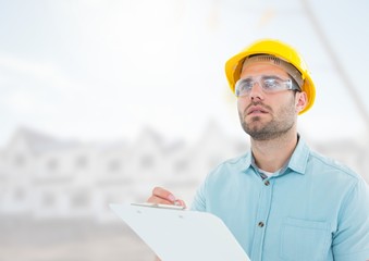 Architect with blueprints on building site