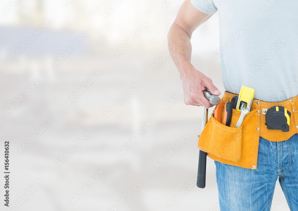 Wall mural Carpenter with tools on building site