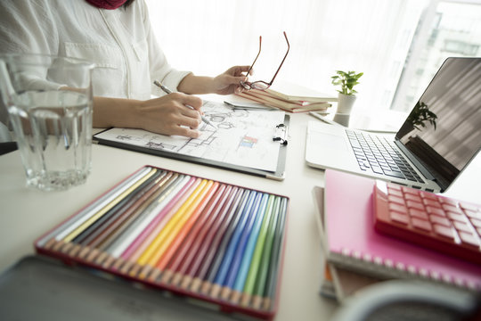 Women draw design sketches in offices