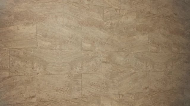 Camera pan showing detail of luxurious travertine marble floor for background 