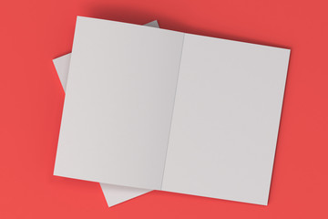 Two blank white open brochure mock-up on red background