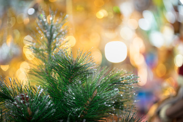 Decorations on christmas tree at night with bokeh on background, soft focus