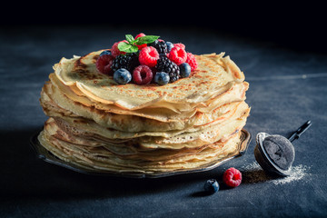 Tasty stack of pancakes with blueberries and raspberries
