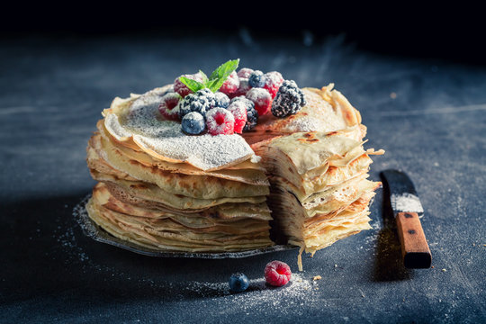 Tasty stack of pancakes with fresh berries and mint