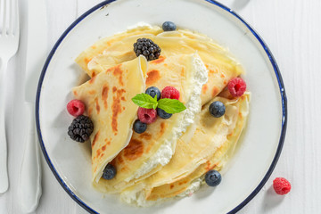 Homemade pancakes with cottage cheese and berries and powder sugar