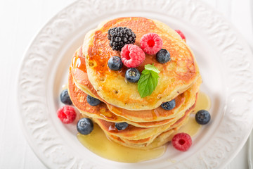 Delicious american pancakes with blueberries and raspberries