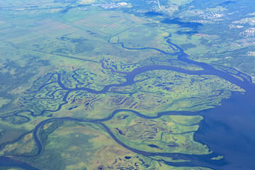 Coast of the Kamchatka Peninsula is cut by water arteries of Pacific Ocean. View from plane.