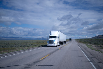 Big rigs semi trucks black and white on Nevada road