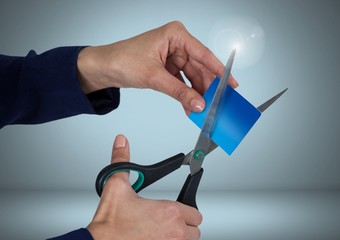 Hands cutting bank card with scissors