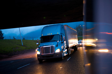 Bright semi truck in raining night lights on highway © vit