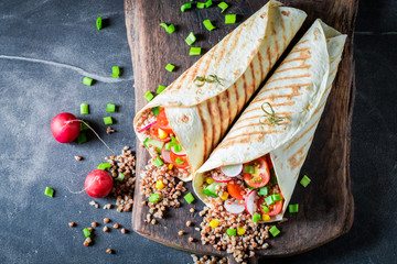 Healthy vegetarian tortilla with groats, chive and cherry tomatoes