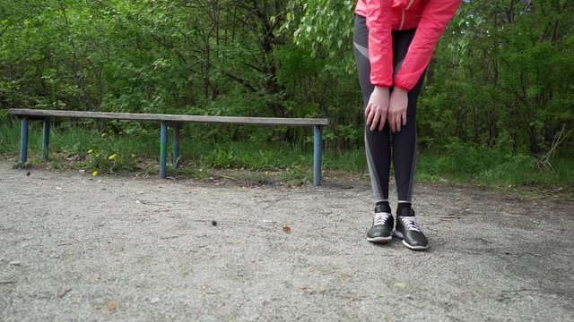 young fitness woman runner stretching legs before run