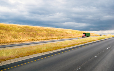 Semi truck on sunny divided California road