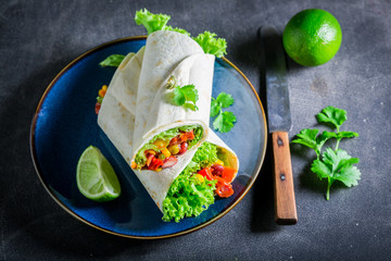Enjoy your burrito with tomato sauce, vegetables and meat