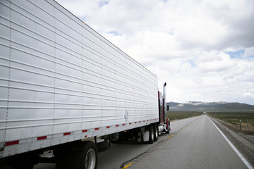 Semi truck rig with reefer driving on oncoming traffic line