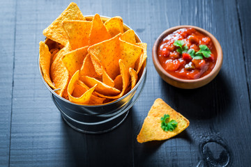 Enjoy your nachos with tomato dip and coriander