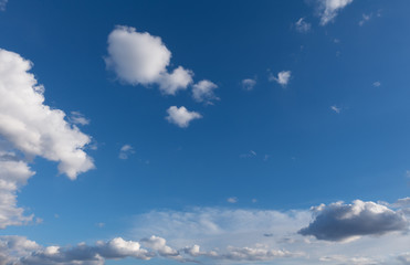 Blue sky with clouds over horizon.