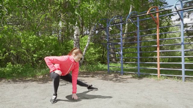 young fitness woman runner stretching legs before run
