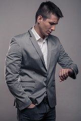 one young man, upper body, formal clothes, looking to watch