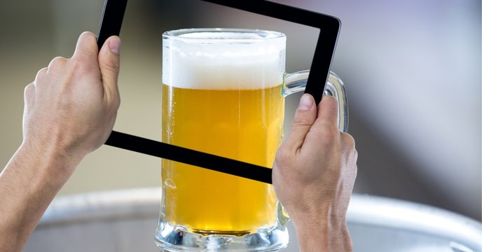 Hand taking picture of beer glass