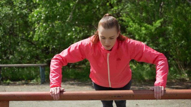 Pretty young caucasian woman training in the park