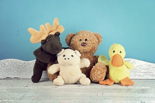 Group of stuffed animal toys on the white wooden table, Animal dolls, Friendship concept.