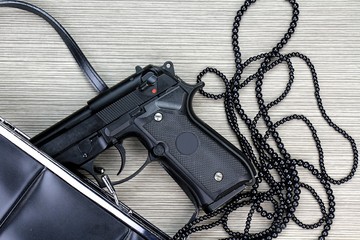 Woman bag with gun hidden, Handgun and accessories falling from a woman's purse.