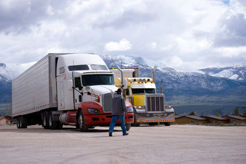 Truck driver going to his semi truck rig on parking lot © vit