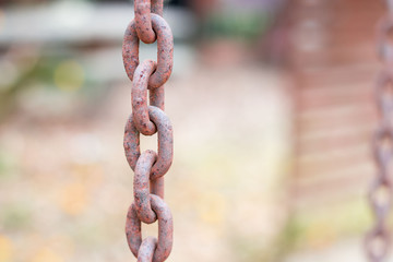 Old red brown rust iron chain with blurred and bokeh background 
