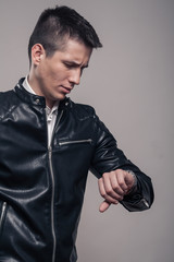 Obraz premium young man, looking to watch, leather jacket,