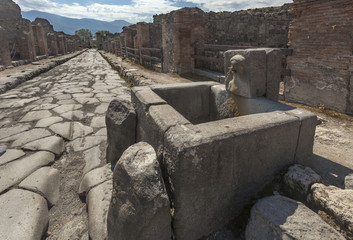 Roman fountain on the street in Pompeii, Italy