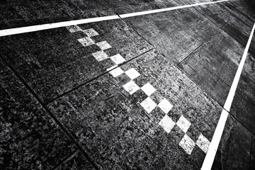 Grunge textured finish and start pattern line on the asphalt race road ground.