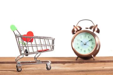 shopping cart and old clock ,time to shopping online