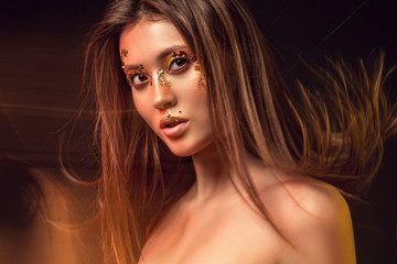 Portrait of a girl, model with beautiful, creative make-up in the studio with color filters. Beauty, portrait, style, fashion, make-up, filters.